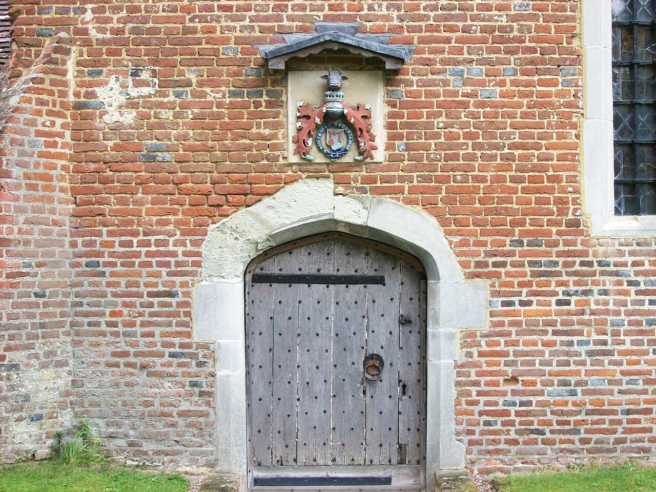 The door of the Hastings Chapel at St Giles' Church, Stoke Poges, with the Hastings coat of arms above it